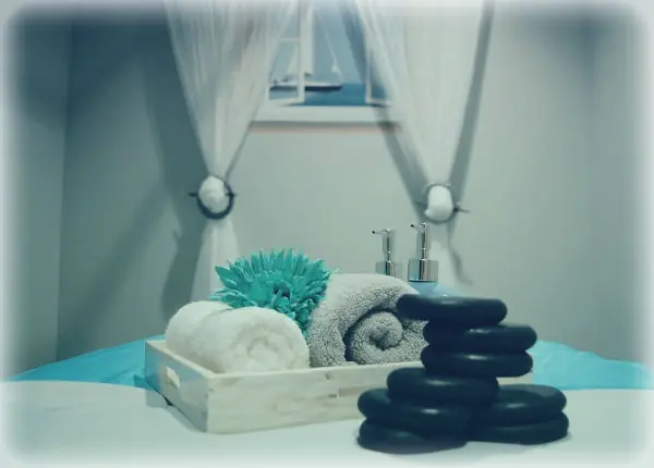 Hot stones and towels on a massage table